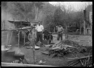 Group of men around a hangi at Te Whaiti, 1930.