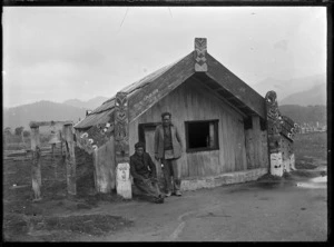 Two men outside the meeting house Te Hau-o-Puanui at Mataatua, Ruatauhuna, 1930.