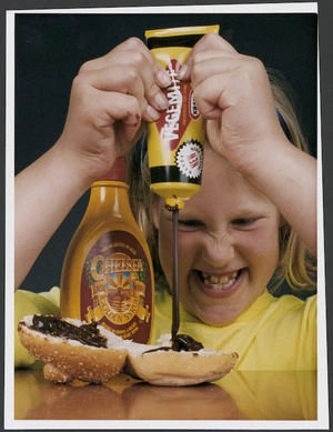 Tamsyn Clemerson trying squeeze packs of Vegemite and golden syrup - Photograph taken by Ross Giblin