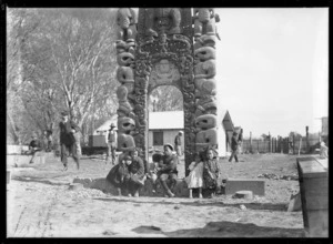 Children beneath waharoa (carved gateway) of inner pa at Christchurch Exhibition