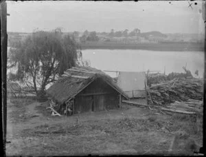 Whare on Whanganui River, with a store of wood