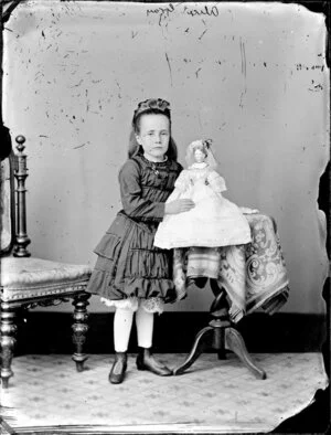 Miss Alice Gray holding a doll, aged 5