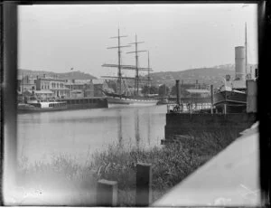 A sailing ship and steamship berthed at Launceston, Tasmania; E & K Brewery and Steam Packet Hotel are amongst the buildings along the river