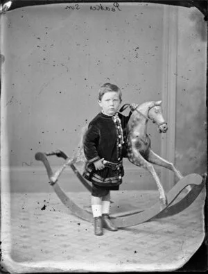 Peake, boy aged 2, by rocking horse