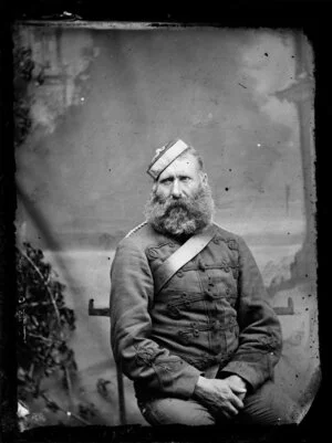 Unidentified man, seated, in military uniform