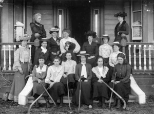Group of women, some with hockey sticks