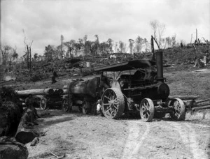 Traction engine transporting logs