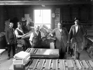 Allen Bell, and others, in a room showing the typesetting equipment of the Northlander newspaper
