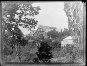View through trees and houses to St Mary's Church, Parnell, Auckland