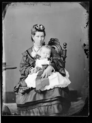 Miss Tynan holding a baby - Photograph taken by Thompson & Daley of Wanganui