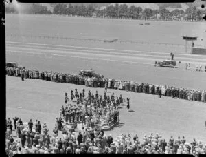 The Lower Hutt Silver Band and a Highland Pipe Band welcome the arrival of Queen Elizabeth II and the Duke of Edinburgh at the Trentham Racecourse, Royal Tour 1953-1954