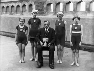 A cup winning lifesaving team with their coach