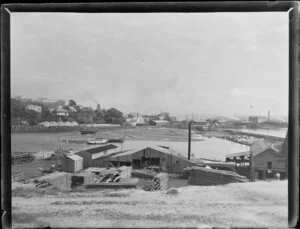 Mechanics Bay, Auckland, featuring timber yard and with railway wharf in the background