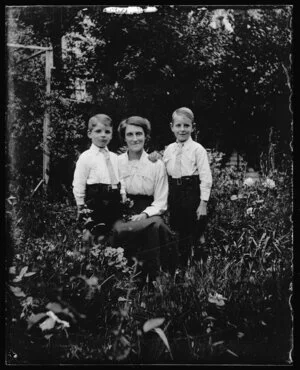 Woman and two small boys in garden