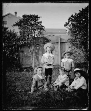 Five small boys in a garden