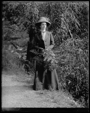 Woman on bank with ferns