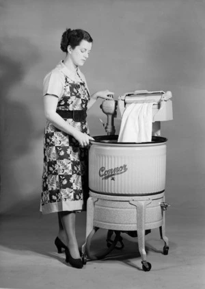 Woman using a wringer washing machine