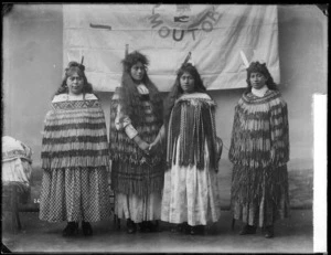 Maori women standing in front of the Moutoa flag - Photograph taken by William Henry Thomas Partington