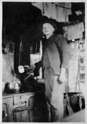Harry Warren at the stove of the homestead at Campbell Island