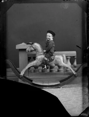 Unidentified boy on rocking horse