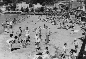 Crowd on the beach at Oriental Bay, Wellington, with weight lifters