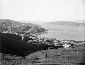 Looking down over the streets and houses of Kilbirnie, Wellington, showing Evans Bay on the right and Point Halswell in the distance