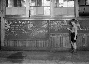 Boy writing on a blackboard