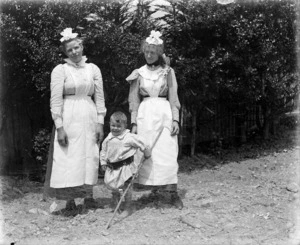 Two women in housekeeping uniforms, and a child