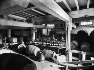 Cellar, showing bottles of sherry and barrels of whiskey