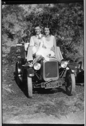 G Young and Curl seated on the bonnet of an Austin 7 car