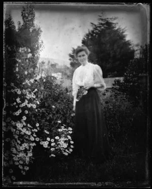 Robina Nicol in garden by daisy bush