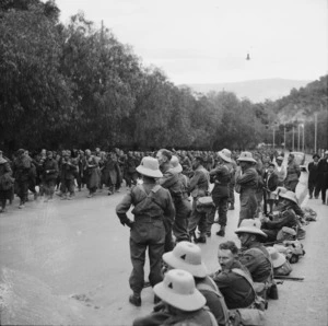 Italian prisoners of war passing New Zealanders of 24th Battalion, A Company, on the road between Piraeus and Athens