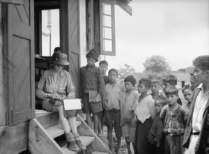 Sadon, Burma. Marie Byles typing at P.W.D. bungalow watched by children, 12 August 1938.