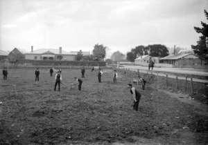 Cricket game in a paddock, intersection of Trafalgar Street and Halifax Street, Nelson