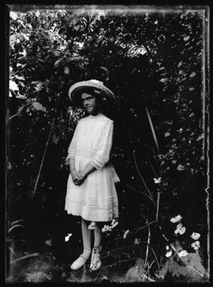 Portrait of unidentified young girl in garden