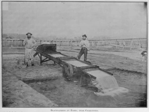 Two men standing by a gold table