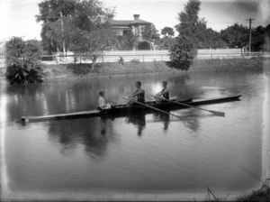 Avon Rowing Club men's coxed pair rowing team with a young boy coxswain on the Avon River, Christchurch
