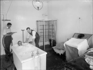 Man undergoing therapeutic treatment in a bath