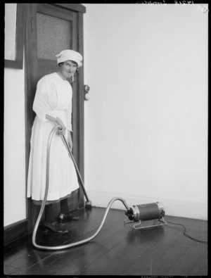 Woman using a Simplex vacuum cleaner