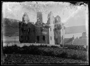 Copy photograph of a ruined stone castle and cottages