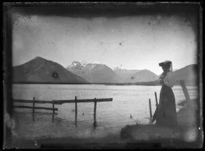 Woman posing beside South Island lake