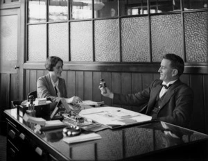 Man and woman seated at a desk