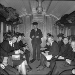 School children travelling by train, and guard, Buller district