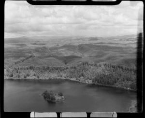 Green Lake (Lake Rotokakahi) western end surrounded by forest with Punaruku Island, Rotorua District, Bay of Plenty Region