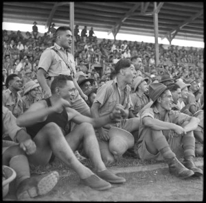 World War 2 soldiers of the Maori Battalion cheering on tug-o-war participants at an athletics meeting, Farouk Stadium, Cairo, Egypt