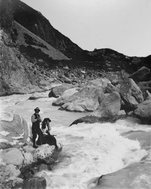 May Kinsey and an unidentified man at the edge of a mountain river