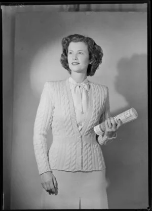 Woman in cardigan holding copy of Stitch magazine