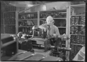 Male factory worker drilling, Philips Electrical Industries of New Zealand Ltd