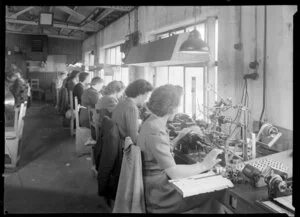 Line of women at factory bench, Philips Electrical Industries of New Zealand Ltd
