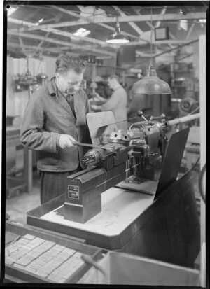 Male factory worker at machine, Philips Electrical Industries of New Zealand Ltd